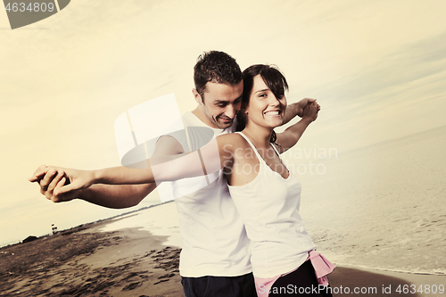 Image of happy young couple have fun at beautiful beach