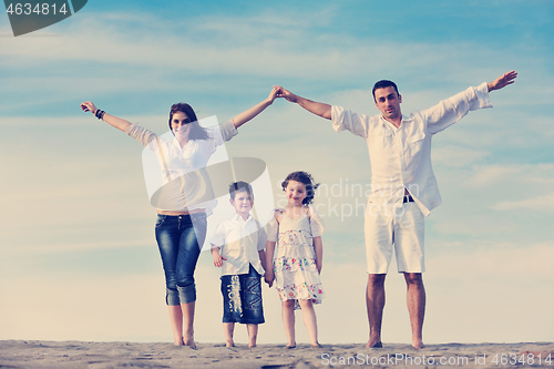 Image of family on beach showing home sign