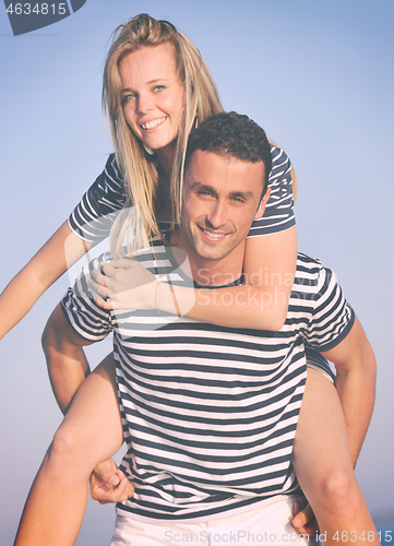 Image of happy young couple have romantic time on beach