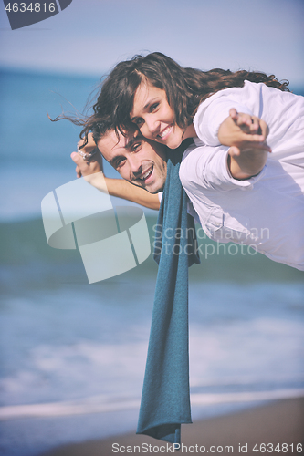 Image of happy young couple have fun at beautiful beach