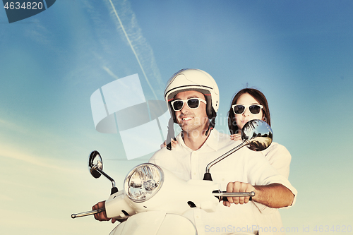 Image of Portrait of happy young love couple on scooter enjoying summer t