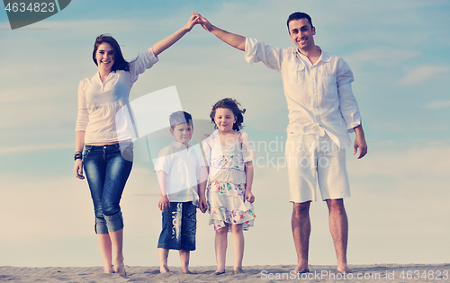 Image of family on beach showing home sign