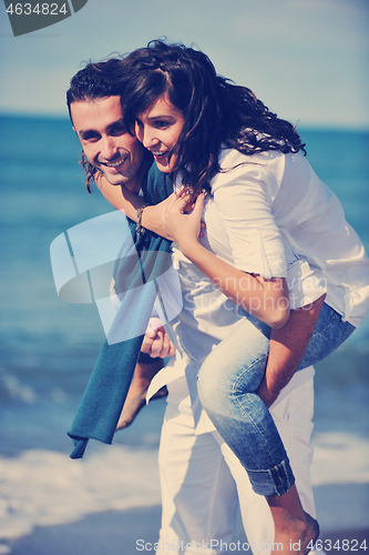 Image of happy young couple have fun at beautiful beach