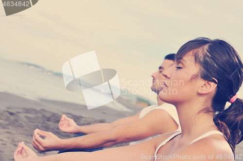 Image of couple yoga beach