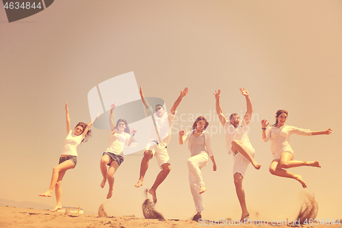 Image of happy people group have fun and running on beach