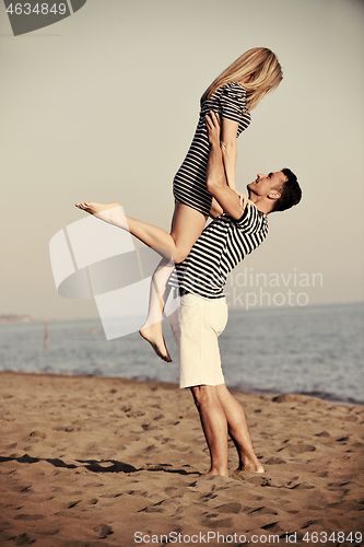 Image of happy young couple have fun on beach