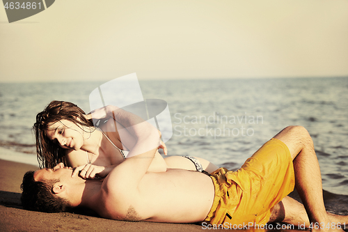 Image of happy young couple have fun on beach