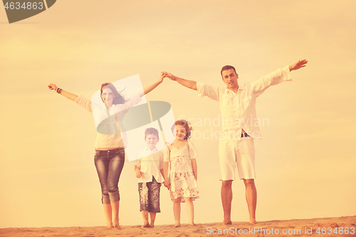 Image of family on beach showing home sign