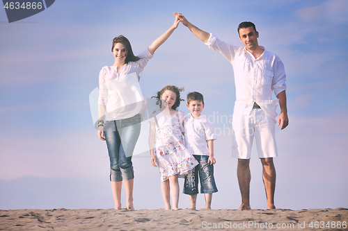 Image of family on beach showing home sign