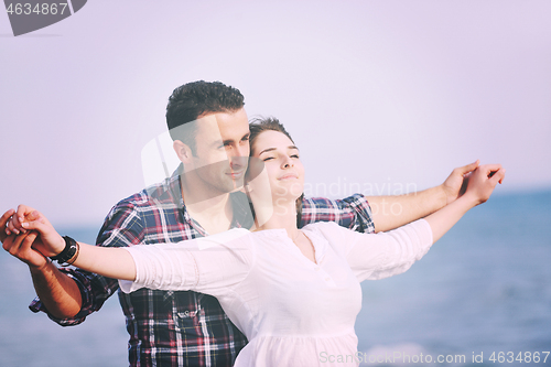 Image of happy young couple have fun on beach