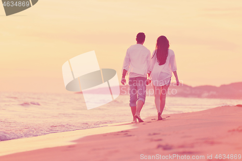 Image of young couple  on beach have fun