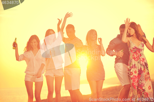 Image of Group of young people enjoy summer  party at the beach
