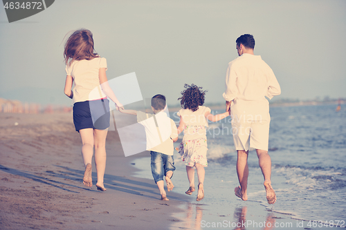 Image of happy young family have fun on beach