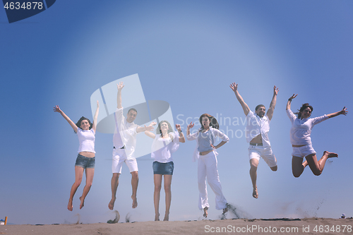 Image of happy people group have fun and running on beach