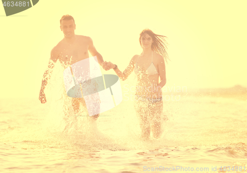 Image of happy young couple have romantic time on beach