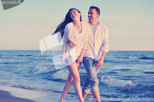 Image of young couple  on beach have fun