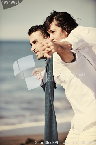 Image of happy young couple have fun at beautiful beach