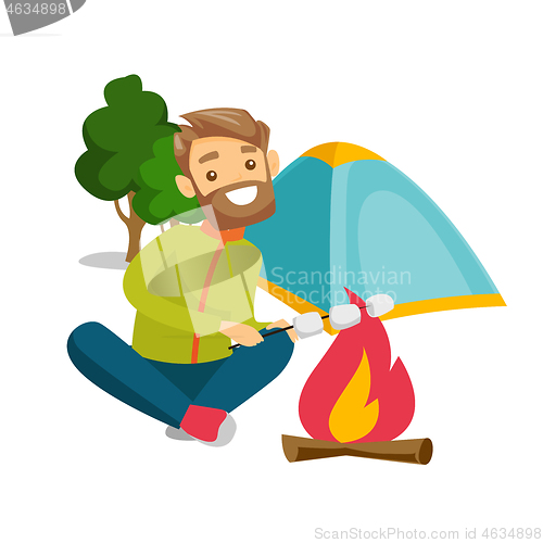 Image of Caucasian man roasting marshmallow over campfire.