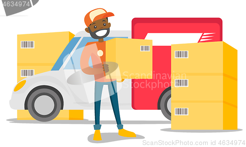 Image of Young african delivery man carrying cardboard box.