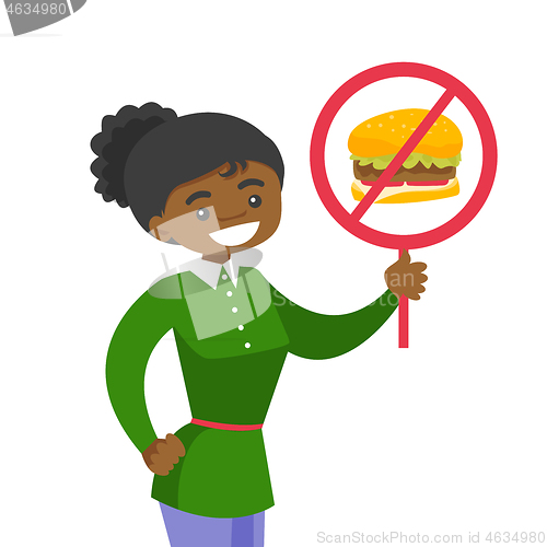Image of Young woman holding placard with no fastfood sign.