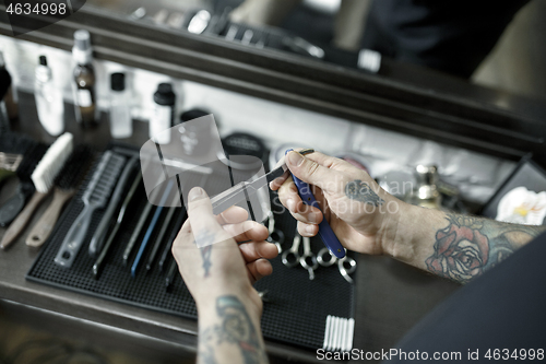 Image of Tools for cutting beard barbershop top view. Vintage tools of barber shop on wooden background