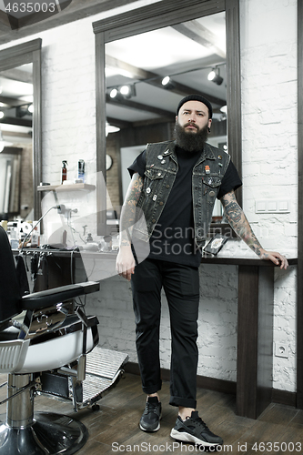 Image of The male hairdresser against a barber shop