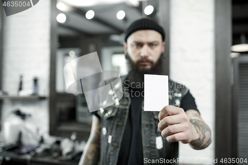 Image of The male hairdresser against a barber shop