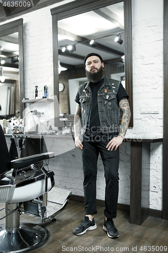 Image of The male hairdresser against a barber shop