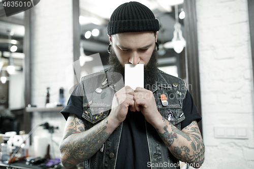 Image of The male hairdresser against a barber shop