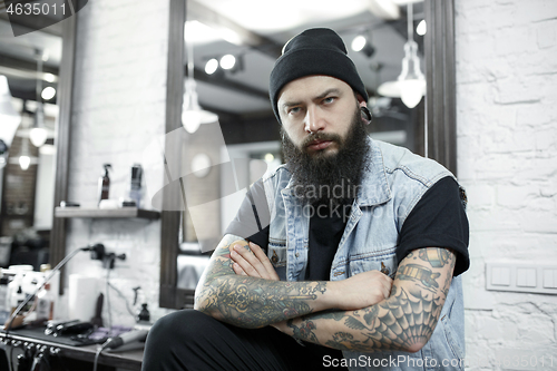 Image of The male hairdresser against a barber shop background.