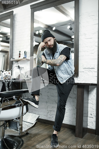 Image of The male hairdresser against a barber shop