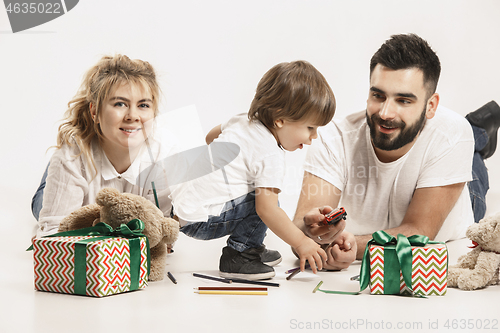 Image of happy family with kid together and smiling at camera isolated on white