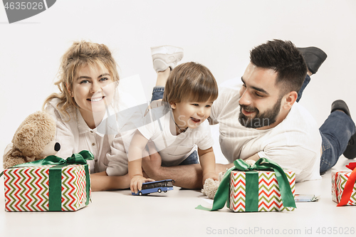 Image of happy family with kid together and smiling at camera isolated on white