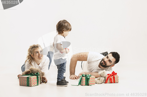 Image of happy family with kid together and smiling at camera isolated on white