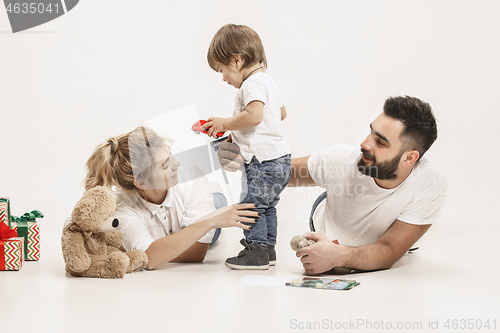 Image of happy family with kid together and smiling at camera isolated on white