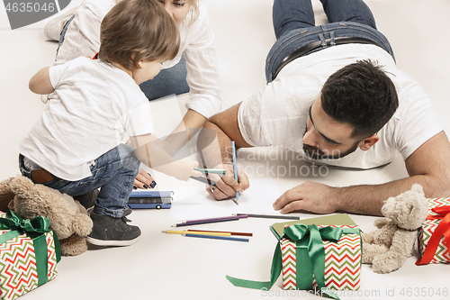 Image of happy family with kid together and smiling at camera isolated on white