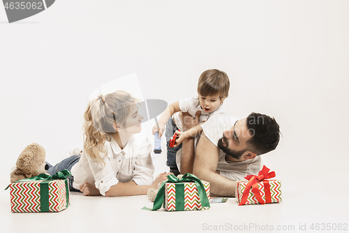Image of happy family with kid together and smiling at camera isolated on white