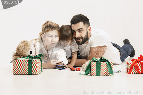 Image of happy family with kid together and smiling at camera isolated on white