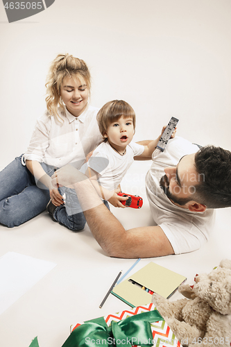 Image of happy family with kid together and smiling at camera isolated on white