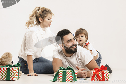 Image of happy family with kid together and smiling at camera isolated on white