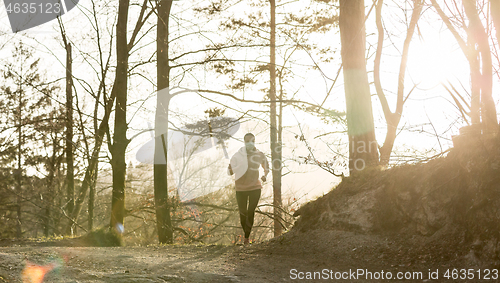 Image of Corona virus, or Covid-19, is spreading all over the world. Portrait of caucasian sporty woman wearing a medical protection face mask while running in nature.