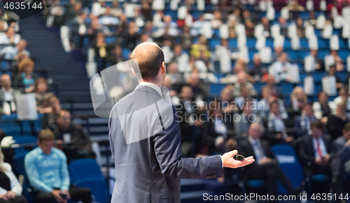 Image of Public speaker giving talk at Business Event.