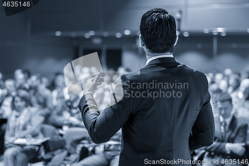 Image of Speaker giving a talk at business conference meeting.