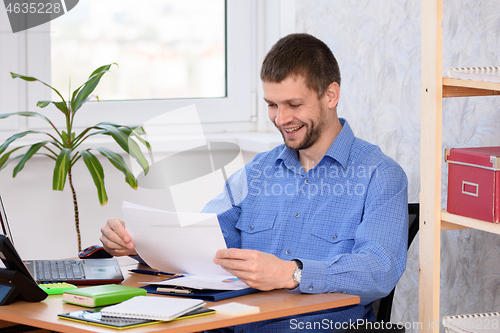 Image of Office employee is happy to read paper documents