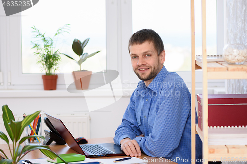Image of Successful businesswoman at her desk in the office