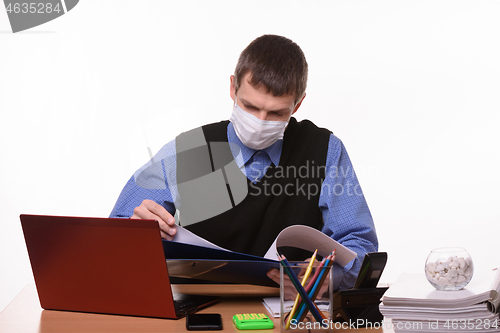 Image of Office clerk leafing through documents in a folder