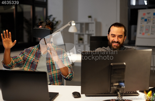 Image of creative man in virtual reality headset at office