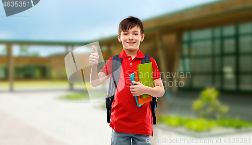 Image of student boy with books and bag showing thumbs up