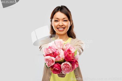 Image of happy asian woman with bunch of flowers