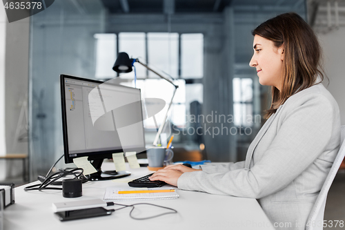 Image of businesswoman with computer working at office